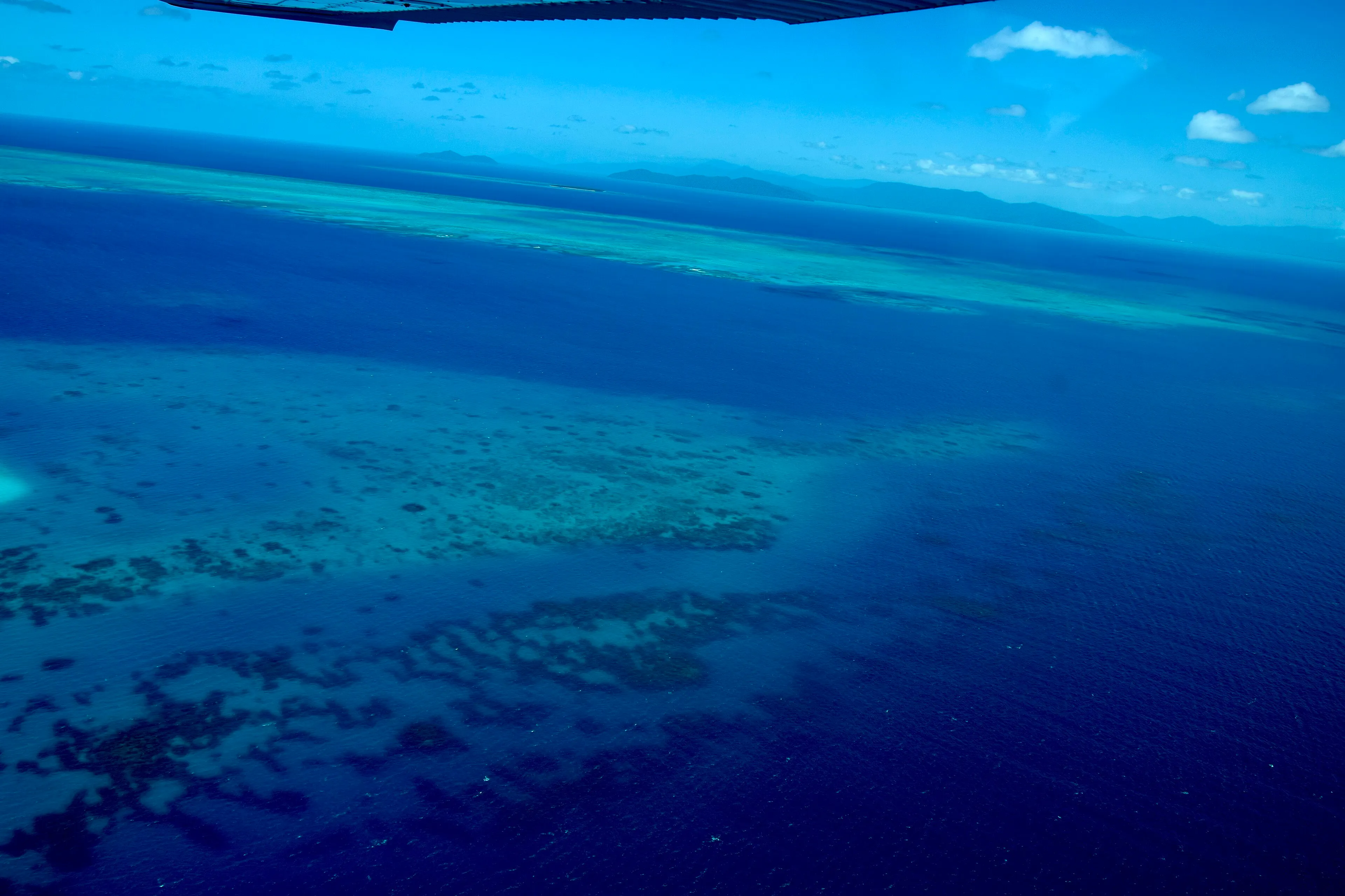 Aerial view of coral reefs and turquoise shallows on the Great Barrier Reef